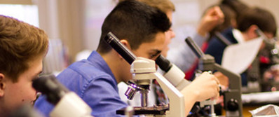 Upper school students uses microscopes in biology class to dig deeper in God's creation.
