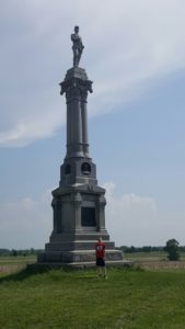 A student with Custer's monument at Gettysburg, PA.