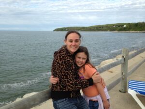 A mother and daughter stand by the bay in Plymouth, MA