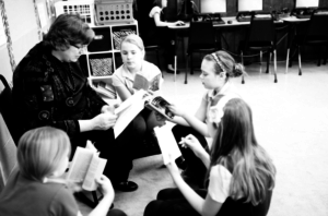 A Dayspring teacher reads to a small group of four girls.