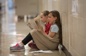 Two Dayspring students read in the hallway of the school.