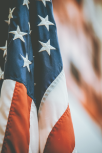 A close up of the American flag displayed indoors. 