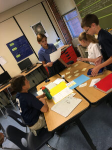 Sixth grade students complete their collaborative assignment in Math class. 